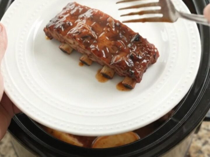 Slow cooker ribs with apples and BBQ sauce, glistening and tender