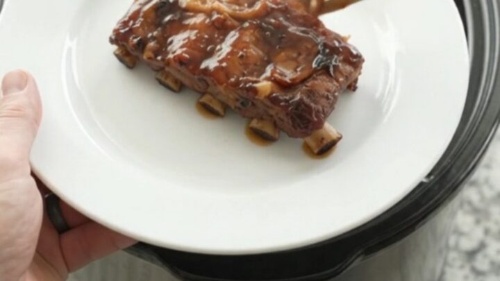 Slow cooker baby back ribs glazed with molasses barbecue sauce and topped with caramelized onions.