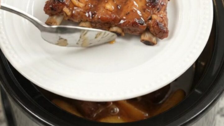 Slow cooker baby back ribs with apples and maple bourbon BBQ sauce, glistening and tender
