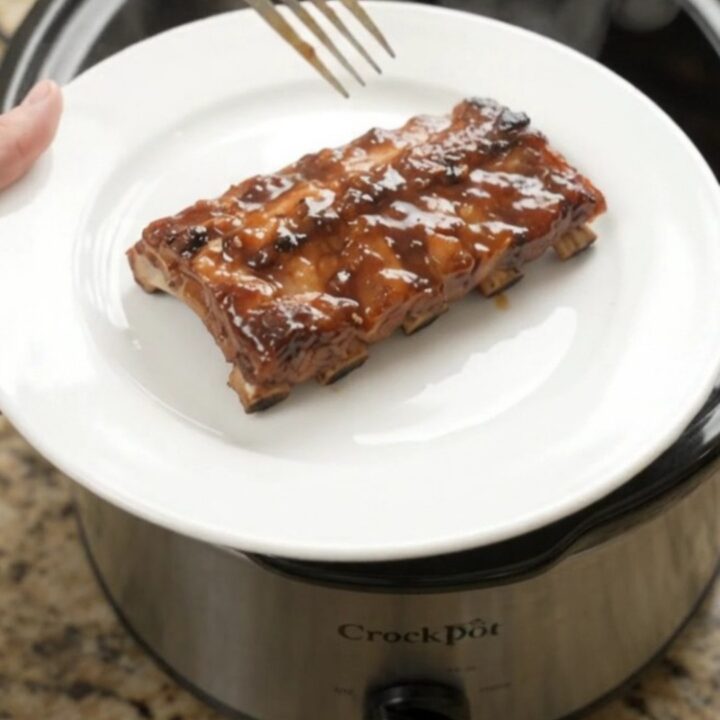 Slow-cooker baby back ribs glazed with molasses barbecue sauce and topped with soft peach slices