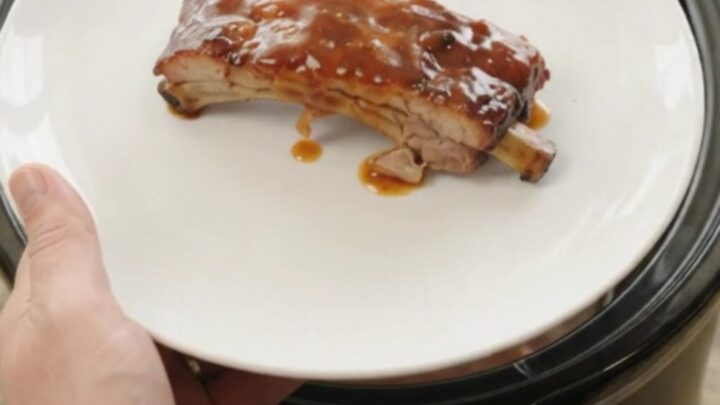 Fall-off-the-bone baby back ribs glazed with sticky chipotle BBQ sauce in a slow cooker