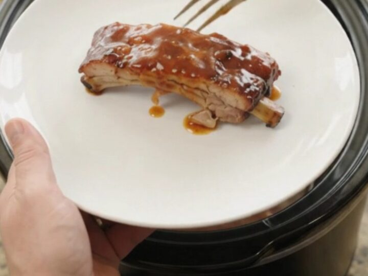 Fall-off-the-bone baby back ribs glazed with sticky chipotle BBQ sauce in a slow cooker