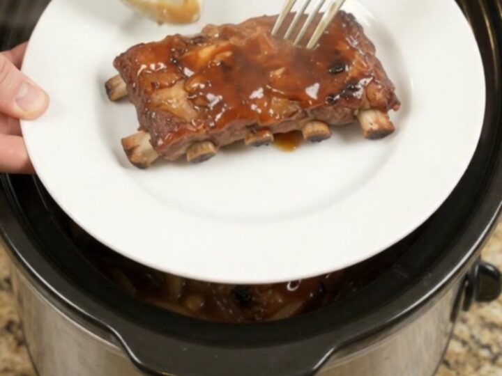 Slow-cooker baby back ribs glazed with honey hickory BBQ sauce and caramelized onions