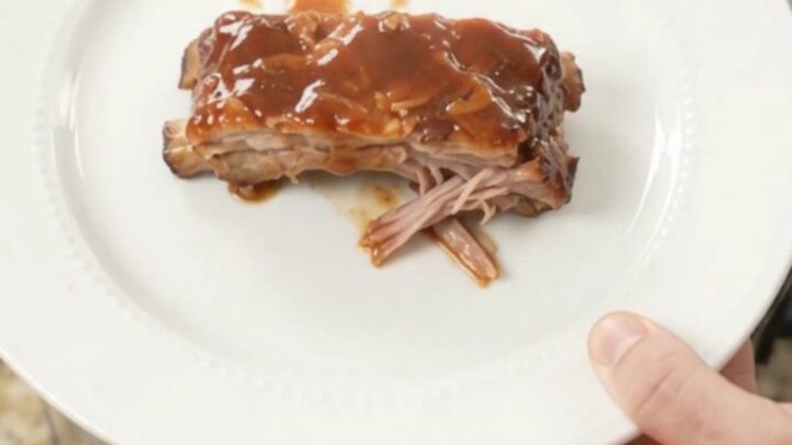Slow cooker brown sugar BBQ spare ribs glistening with sauce in the Crockpot
