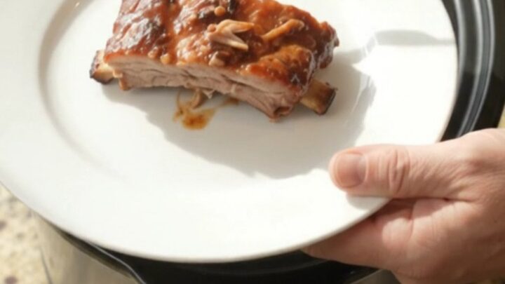 Slow cooker spare ribs coated in glossy BBQ sauce with paprika rub