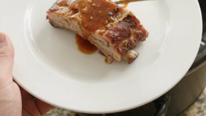 Tender slow-cooker spare ribs glazed with maple bourbon barbecue sauce in the crockpot