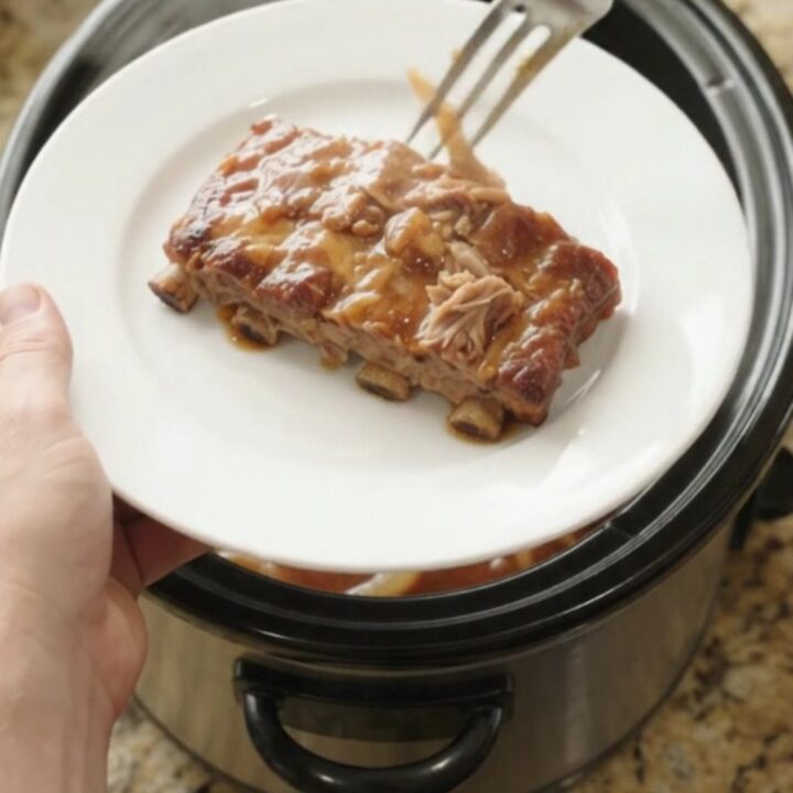 Slow cooker spare ribs glazed with honey hickory sauce and topped with caramelized onions.