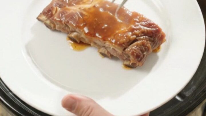 Slow cooker spare ribs glazed in root beer maple bourbon sauce with caramelized onions.
