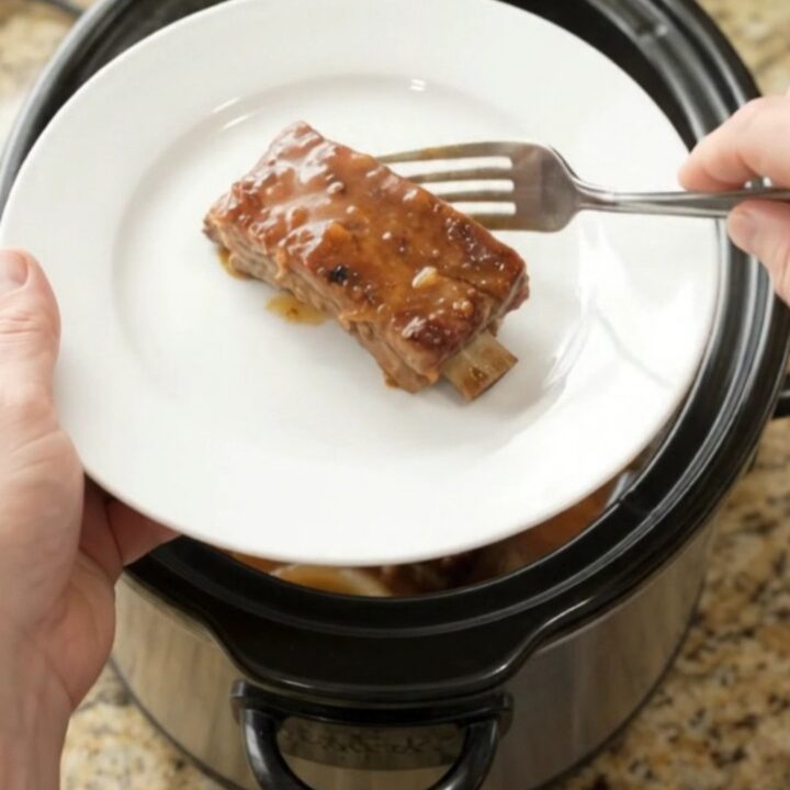 Tender country-style pork ribs glazed in maple-bourbon barbecue sauce in a slow cooker