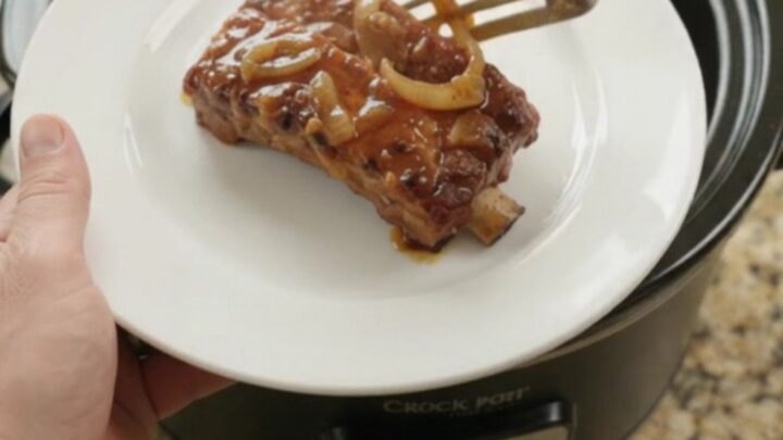 Slow cooker country-style pork ribs with glossy honey-hickory BBQ glaze and caramelized onions