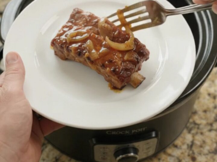 Slow cooker country-style pork ribs with glossy honey-hickory BBQ glaze and caramelized onions