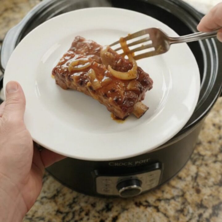 Slow cooker country-style pork ribs with glossy honey-hickory BBQ glaze and caramelized onions