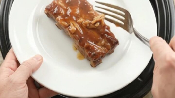 Slow-cooker pineapple maple bourbon country pork ribs with caramelized pineapple rings in glossy sauce.