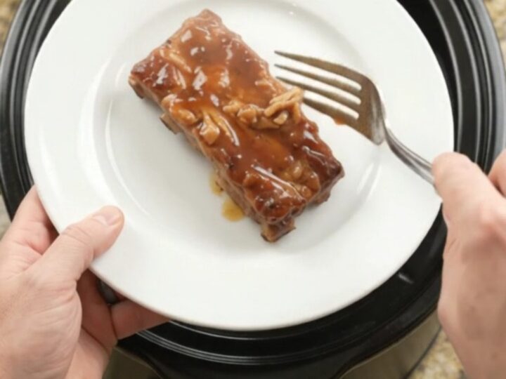 Slow-cooker pineapple maple bourbon country pork ribs with caramelized pineapple rings in glossy sauce.