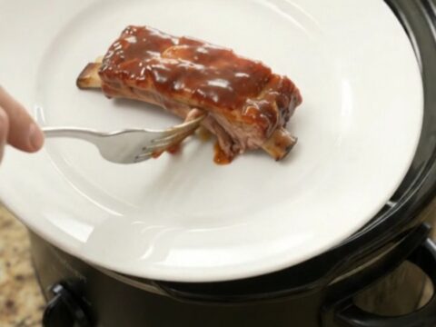 Slow cooker full of glazed pork ribs in chipotle BBQ sauce
