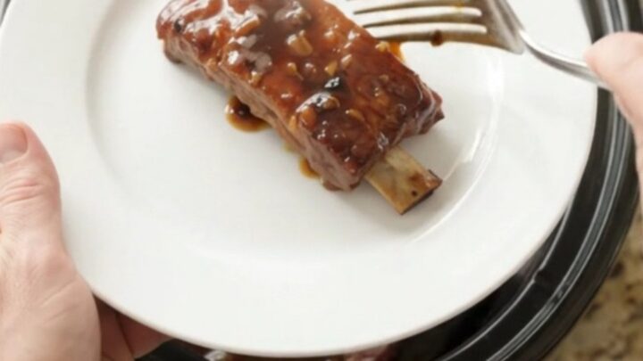 Crockpot with glazed country pork ribs in dark molasses sauce