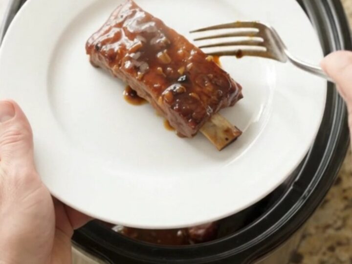 Crockpot with glazed country pork ribs in dark molasses sauce