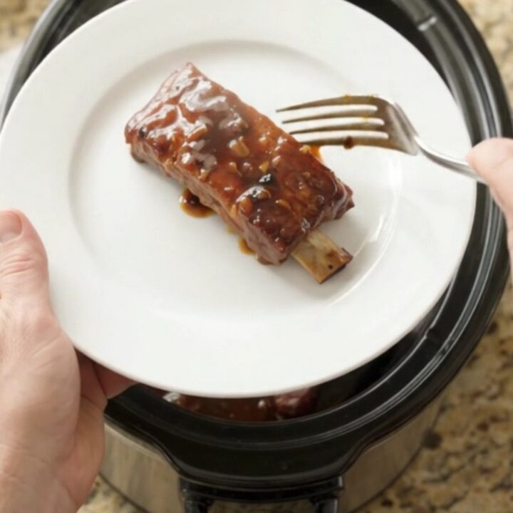 Crockpot with glazed country pork ribs in dark molasses sauce