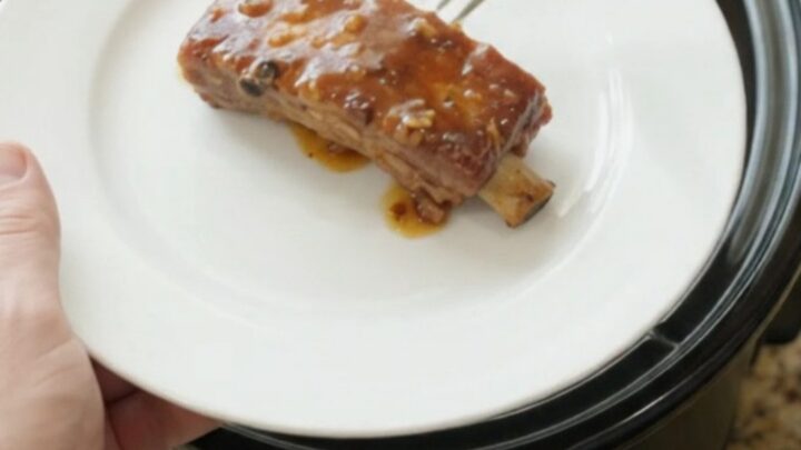 Fork-tender country-style pork ribs glazed with maple bourbon BBQ sauce in a slow cooker