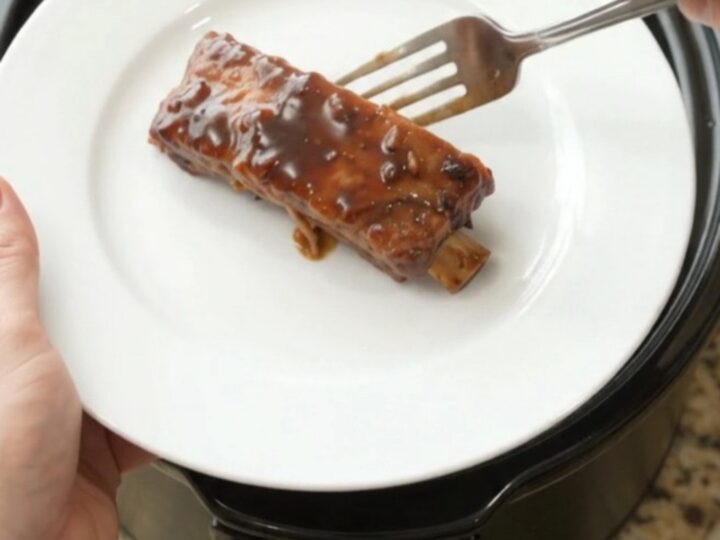 Glazed country-style pork ribs in a slow cooker with garlic and rosemary