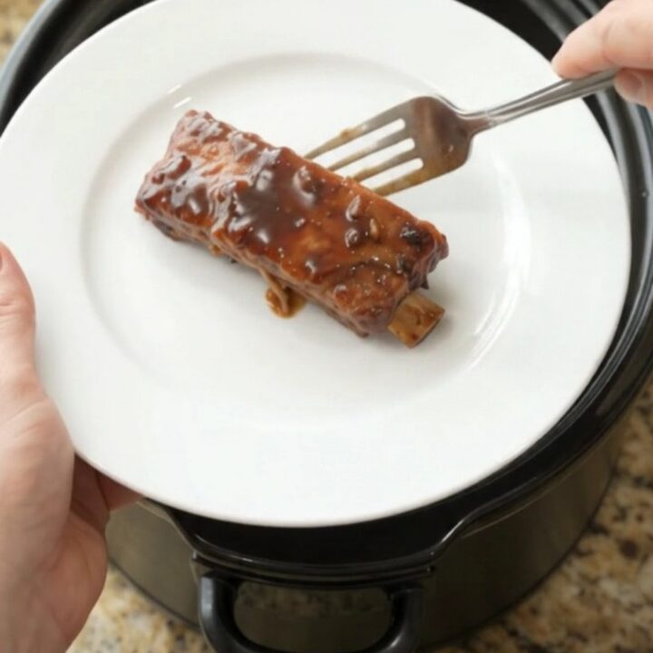 Glazed country-style pork ribs in a slow cooker with garlic and rosemary