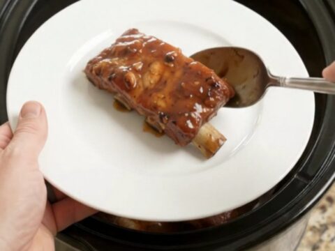 Slow cooker country pork ribs glazed with honey hickory BBQ sauce, fork-tender and steaming.