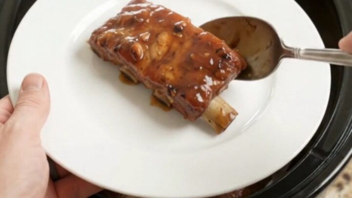 Slow cooker country pork ribs glazed with honey hickory BBQ sauce, fork-tender and steaming.