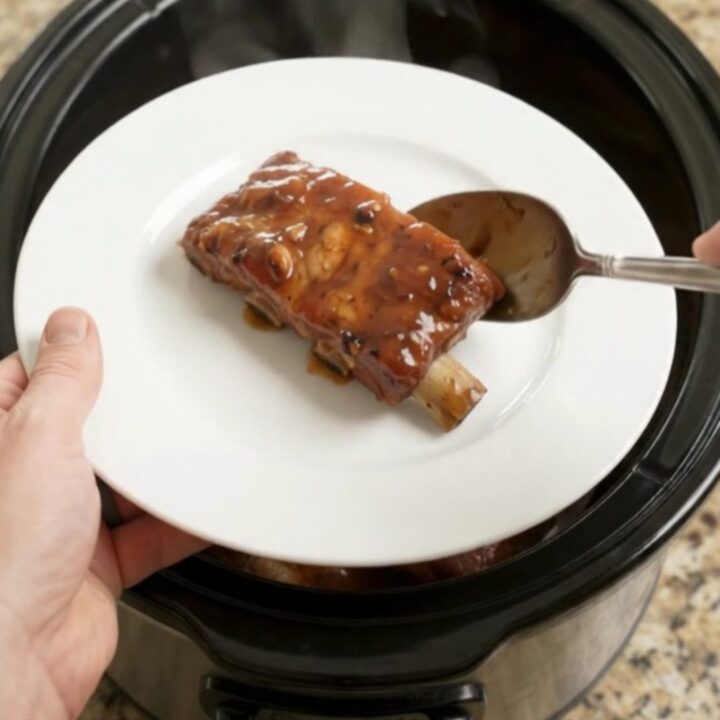 Slow cooker country pork ribs glazed with honey hickory BBQ sauce, fork-tender and steaming.