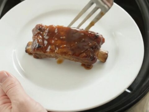 Slow cooker country pork ribs glazed with molasses garlic sauce and caramelized onions