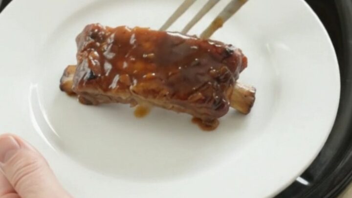 Slow cooker country pork ribs glazed with molasses garlic sauce and caramelized onions