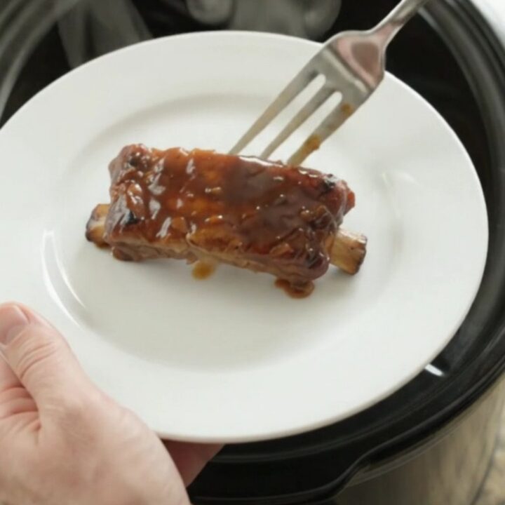 Slow cooker country pork ribs glazed with molasses garlic sauce and caramelized onions