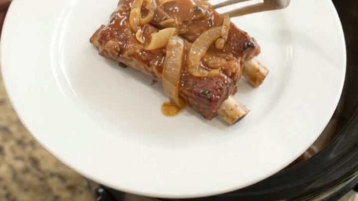 Tender country-style pork ribs glazed in root beer maple bourbon BBQ sauce in a slow cooker
