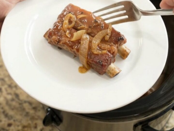 Tender country-style pork ribs glazed in root beer maple bourbon BBQ sauce in a slow cooker