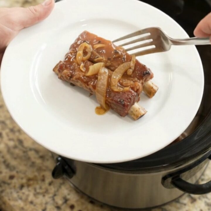 Tender country-style pork ribs glazed in root beer maple bourbon BBQ sauce in a slow cooker