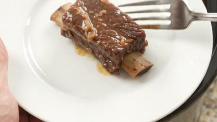 Slow-cooker pineapple molasses beef short ribs in a black crockpot