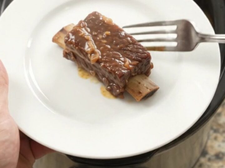Slow-cooker pineapple molasses beef short ribs in a black crockpot