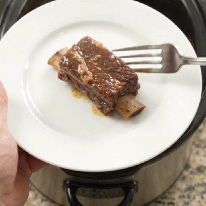 Slow-cooker pineapple molasses beef short ribs in a black crockpot