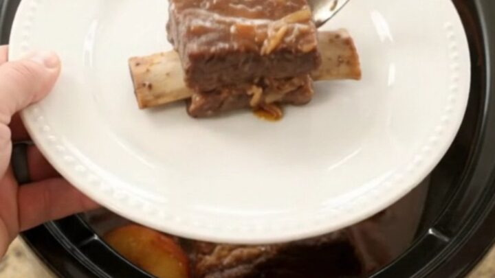 Slow-cooked beef short ribs glazed with honey hickory BBQ and peaches in a Crockpot