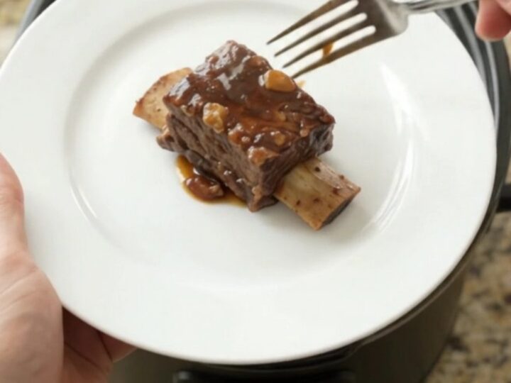 Slow-cooker beef short ribs in a glossy molasses garlic sauce with rosemary