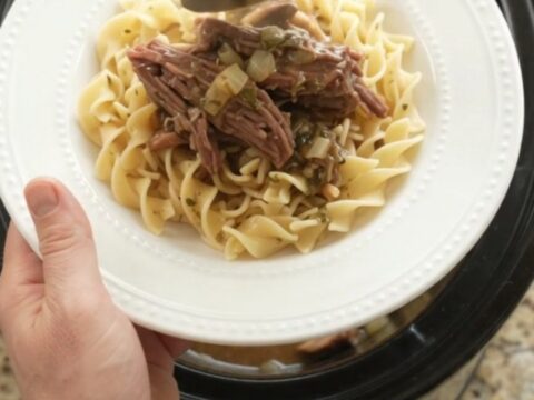 Shredded chuck roast in slow cooker with mushrooms and gravy