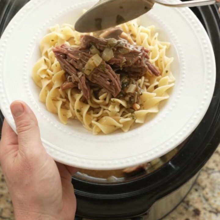 Shredded chuck roast in slow cooker with mushrooms and gravy