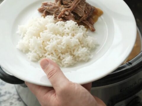 Shredded beef chuck roast with caramelized onions and creamy Dijon sauce in a slow cooker