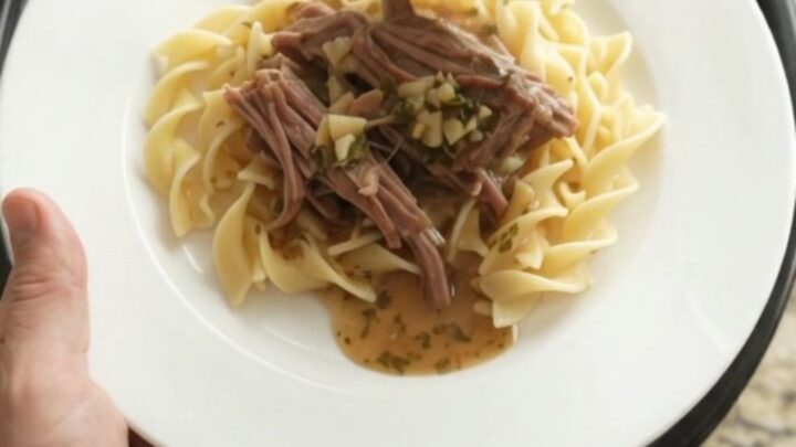 Slow cooker chuck roast with shallots and carrots in rich garlic butter gravy