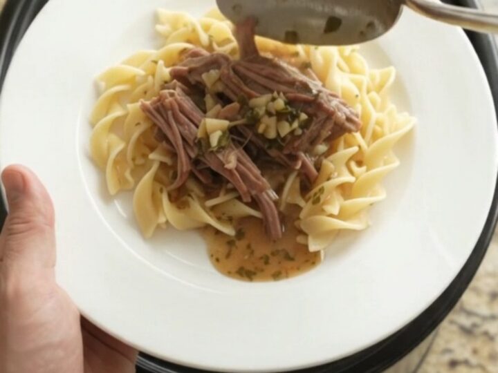 Slow cooker chuck roast with shallots and carrots in rich garlic butter gravy