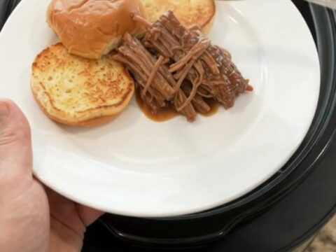 Slow-cooked beef chuck roast with shallots and carrots in rich brown gravy