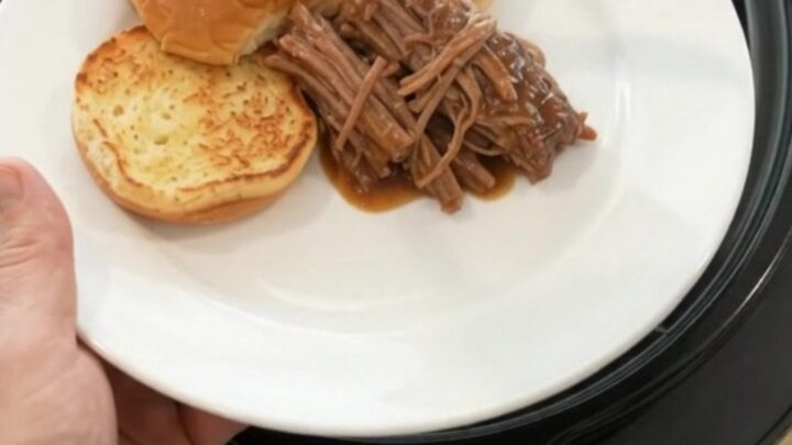 Slow-cooked beef chuck roast with shallots and carrots in rich brown gravy