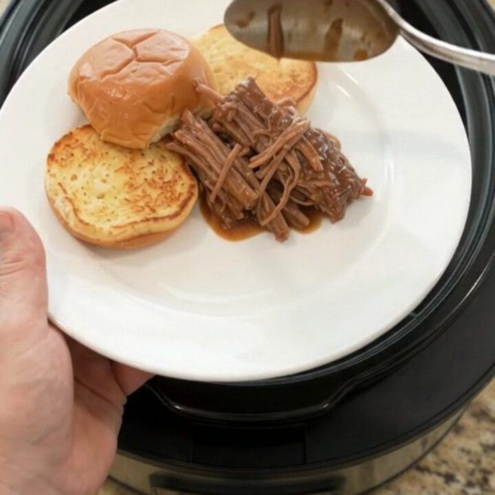 Slow-cooked beef chuck roast with shallots and carrots in rich brown gravy