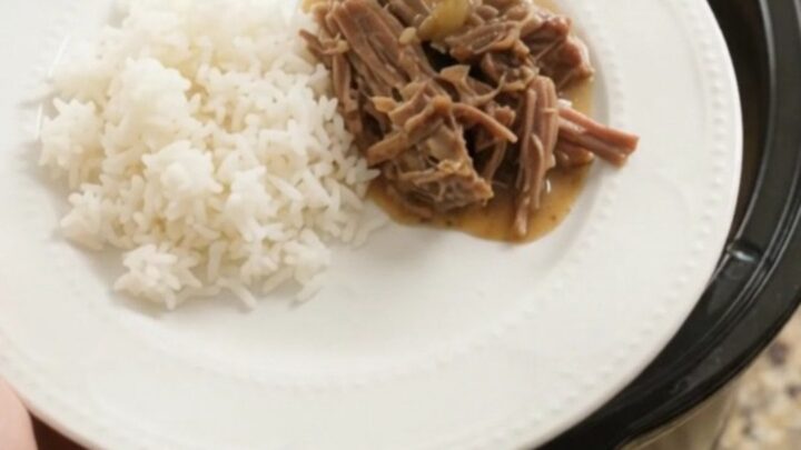 Slow-cooker Dijon cream chuck roast with herbs, shredded and served over rice