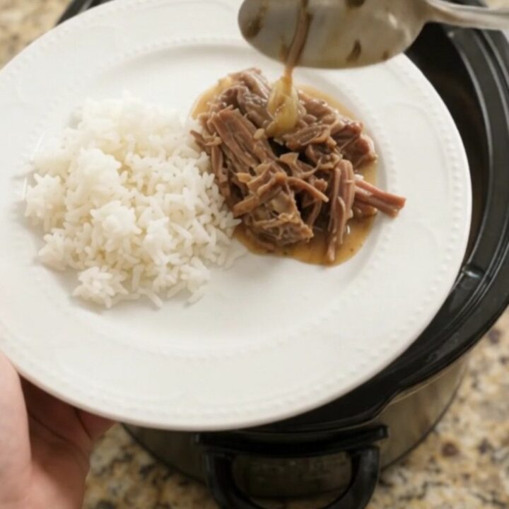 Slow-cooker Dijon cream chuck roast with herbs, shredded and served over rice
