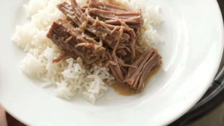 Shredded beef chuck roast with creamy Dijon gravy in a slow cooker